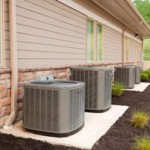 row of heat pumps outside a home